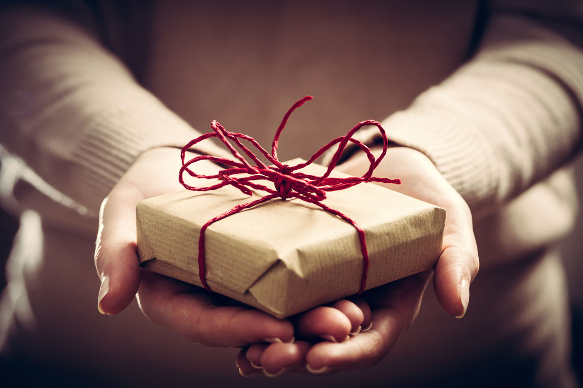 hands holding wrapped holiday gift