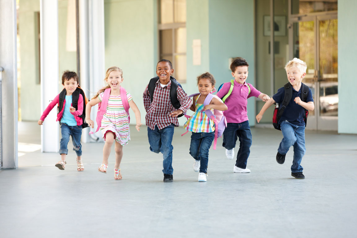 children happily running outside of school