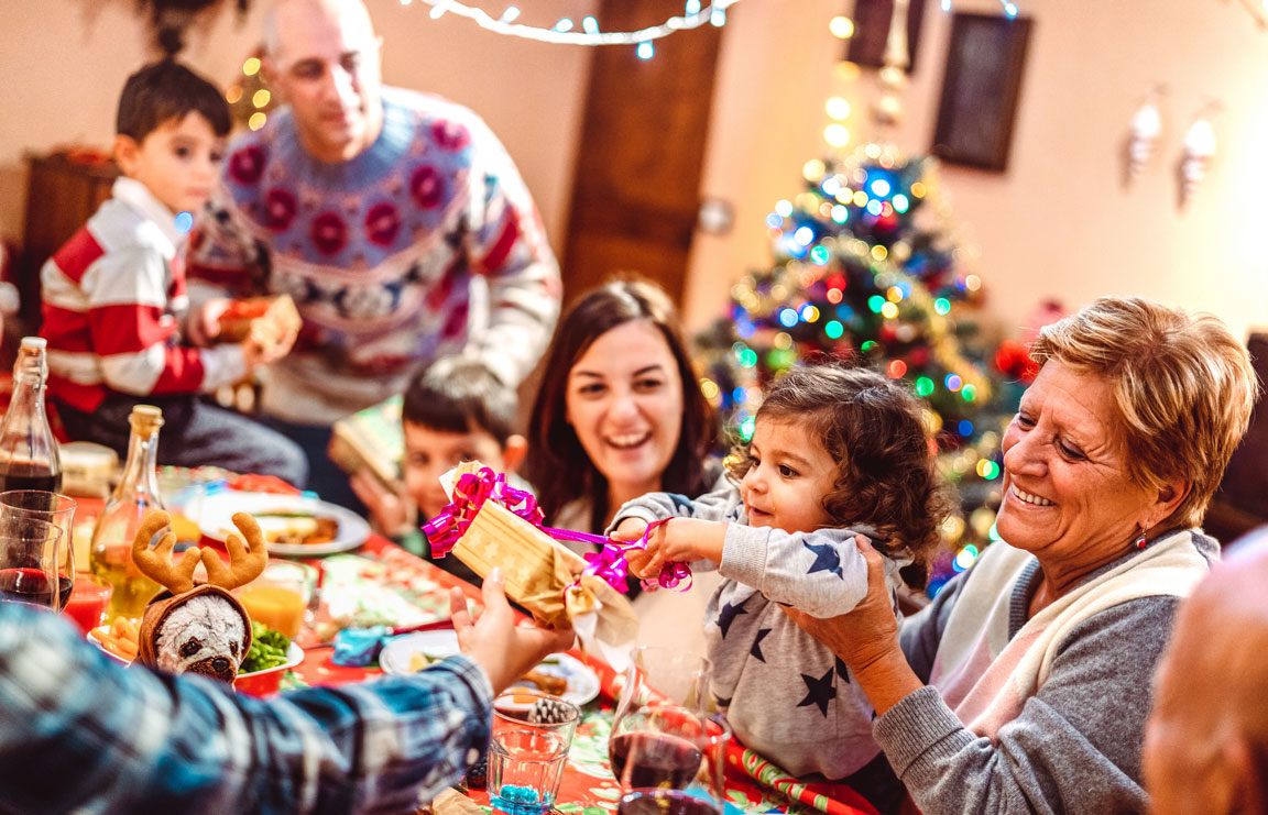 family celebrating Christmas at dinner table