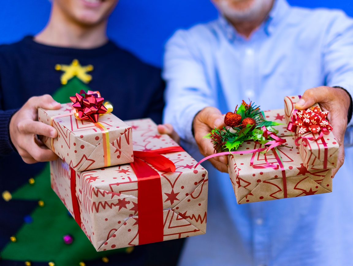 two men holding holiday gifts